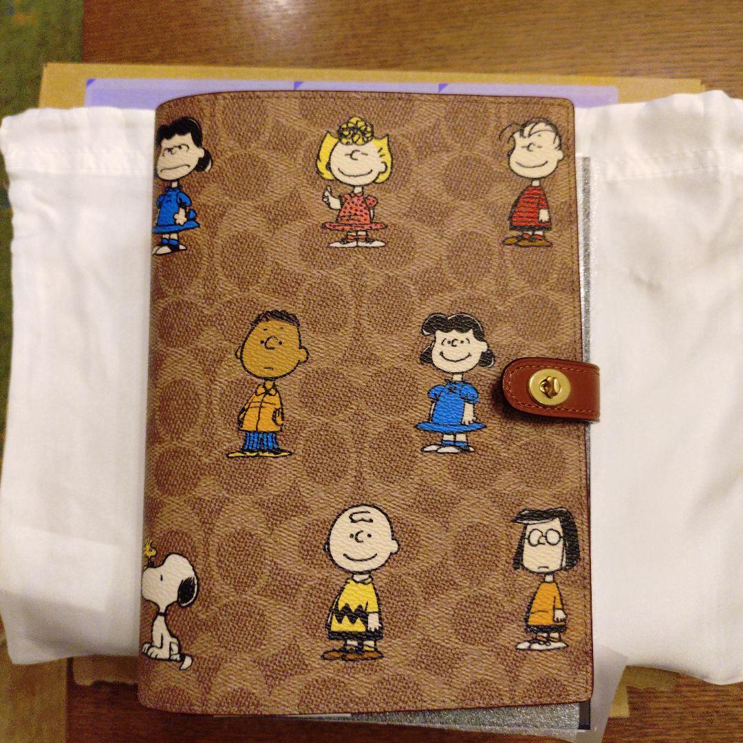 コーチ　スヌーピーコラボ　ノートブックシグネチャーキャンバス