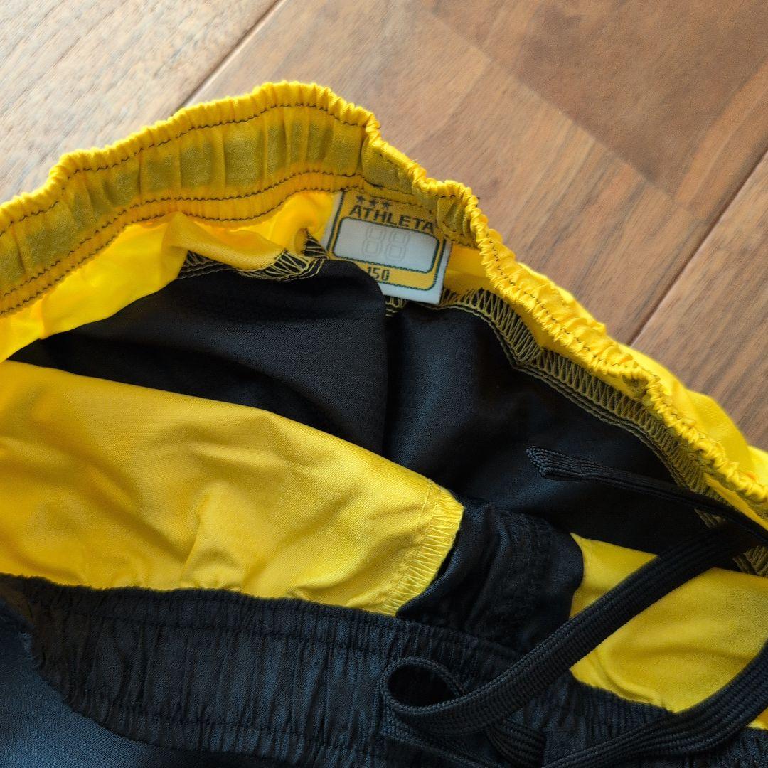 ATHLETA ピステ上下セット 150 黒/黄色